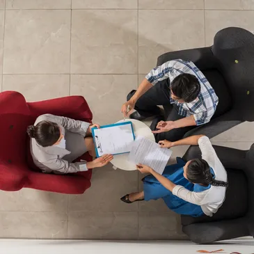 Overview of three people having a meeting